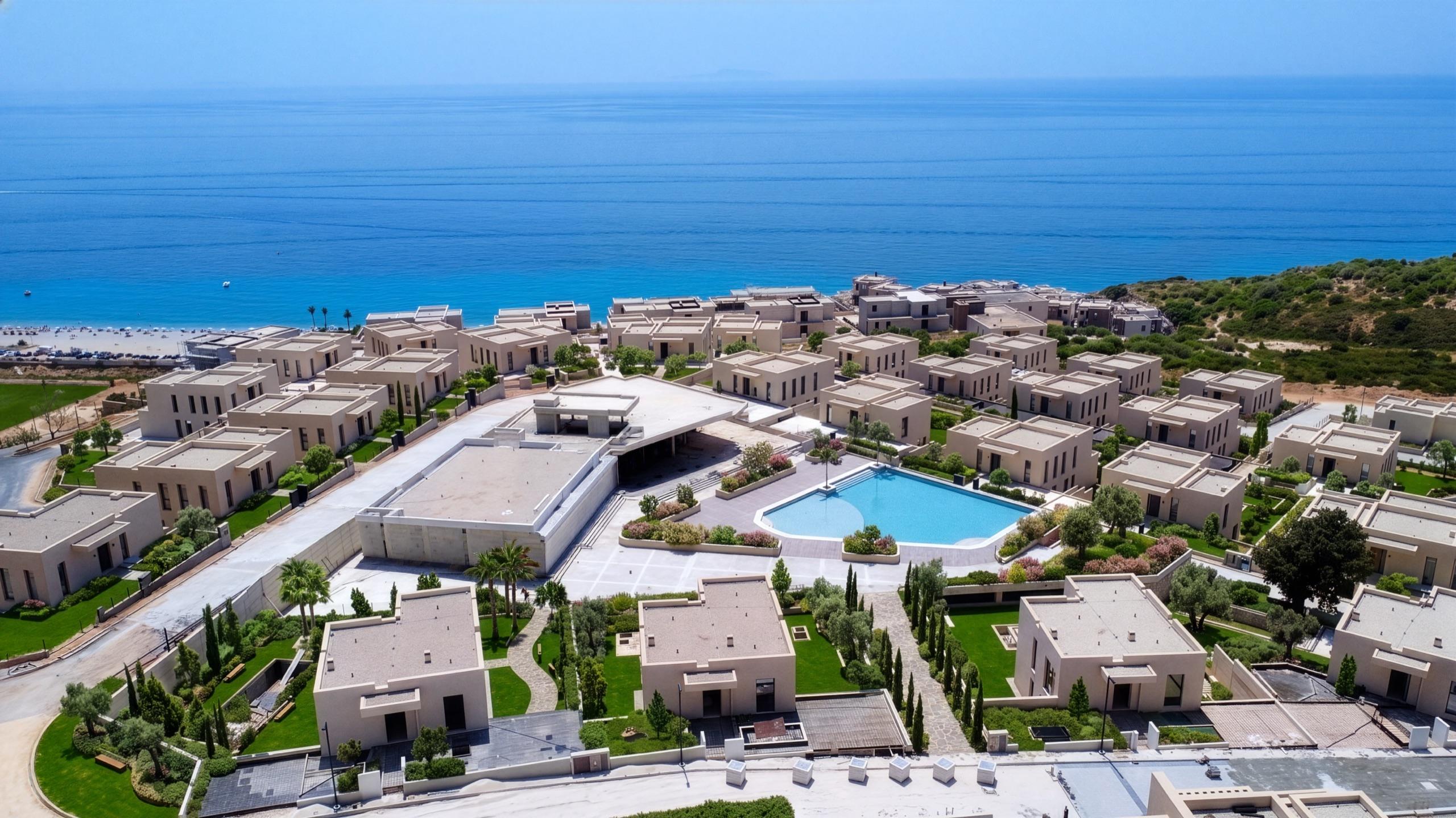 Aerial view of San Nicolas Complex — villas, pool and residences beside the Ionian Riviera coastline