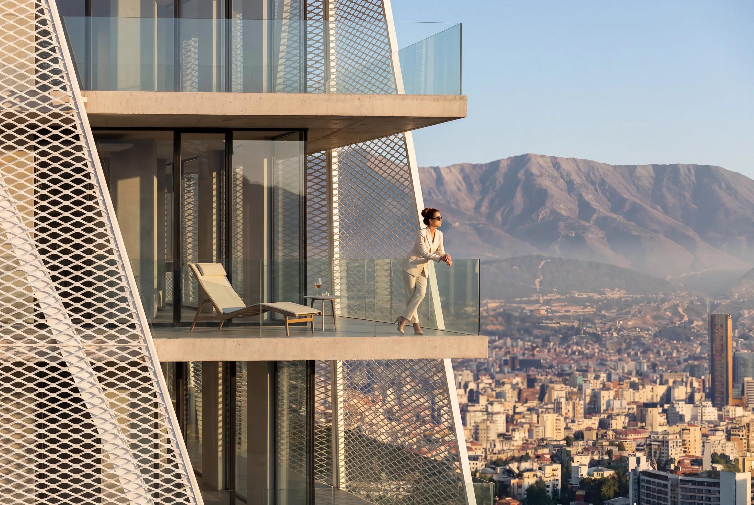 A resident on a private balcony overlooking Tirana and the mountains