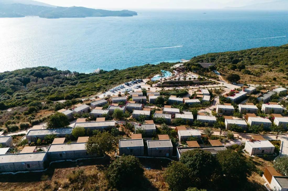 The resort villas stepping down the wooded hillside to the sea