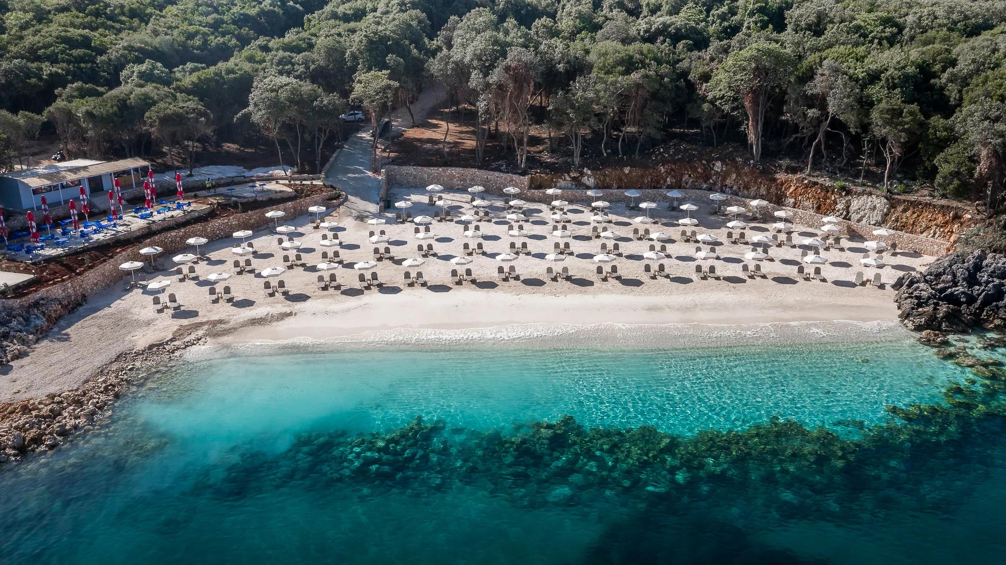 The sheltered cove with sun loungers along the shoreline