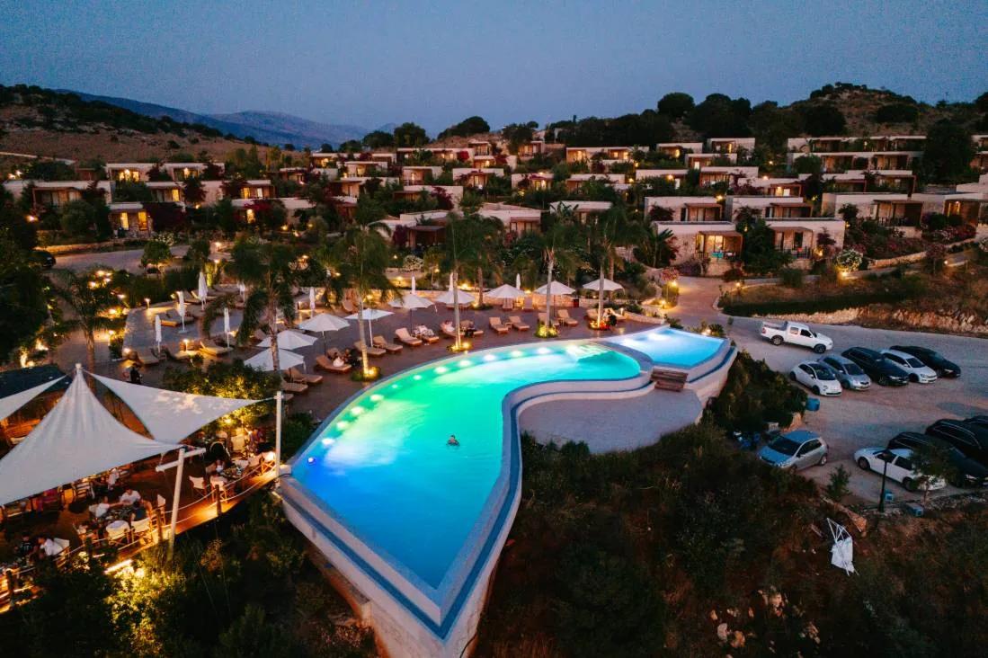 The lagoon pool and terraces lit after sunset
