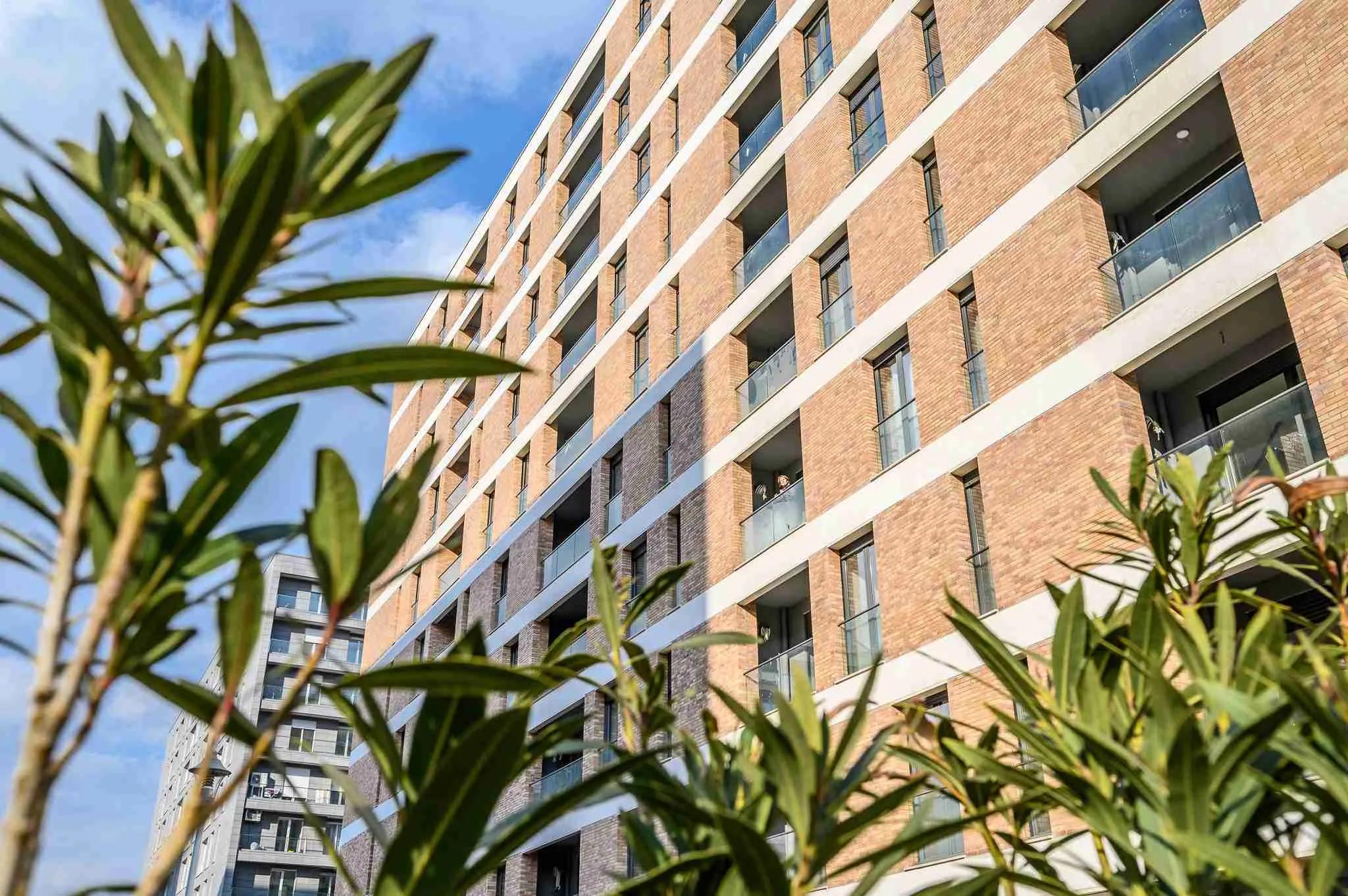 The brick elevation framed by planting