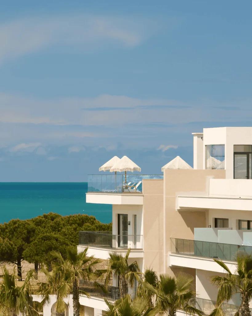 The white beachfront wing above turquoise water
