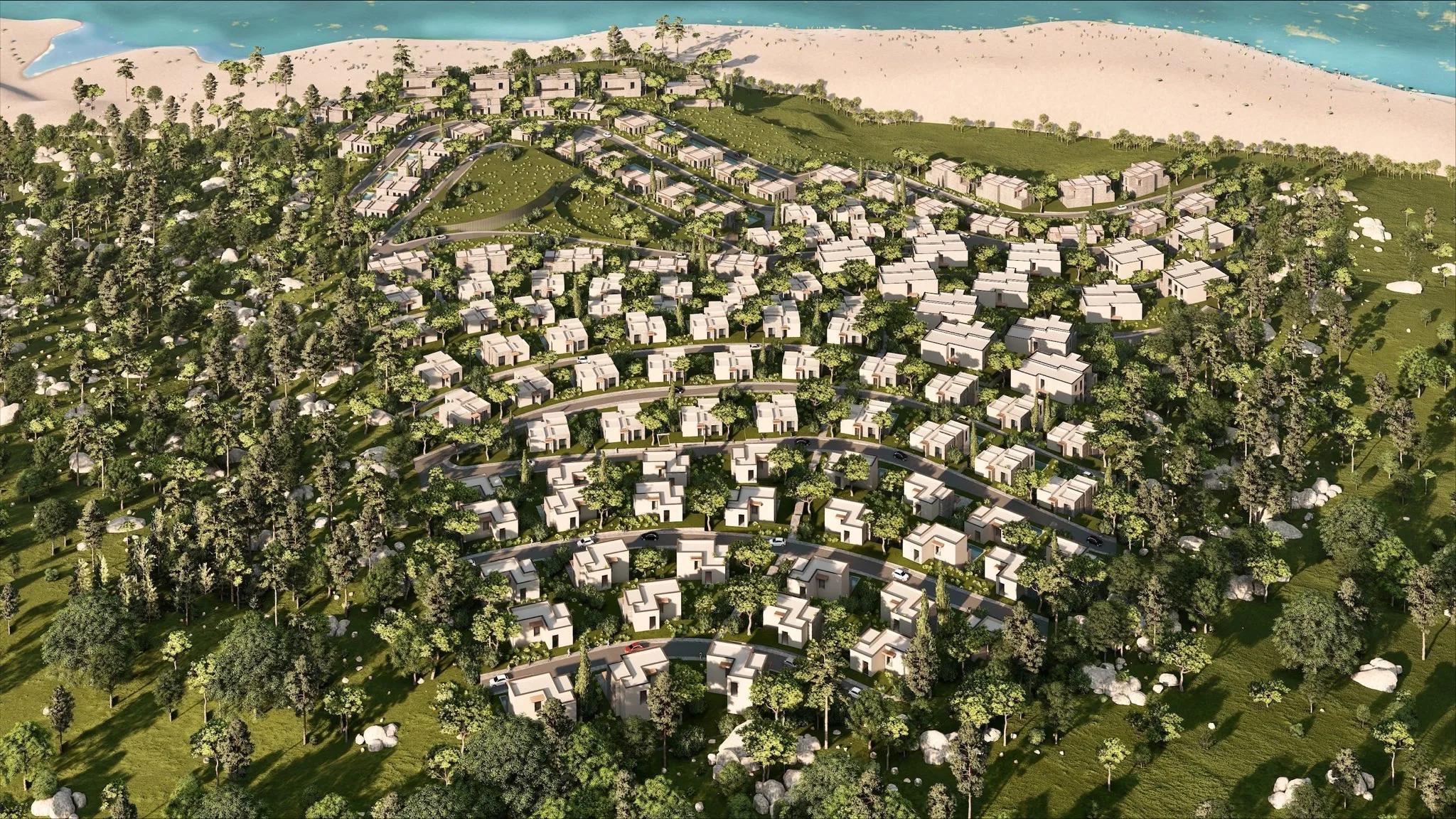 The villas stepping down the wooded hillside to the beach