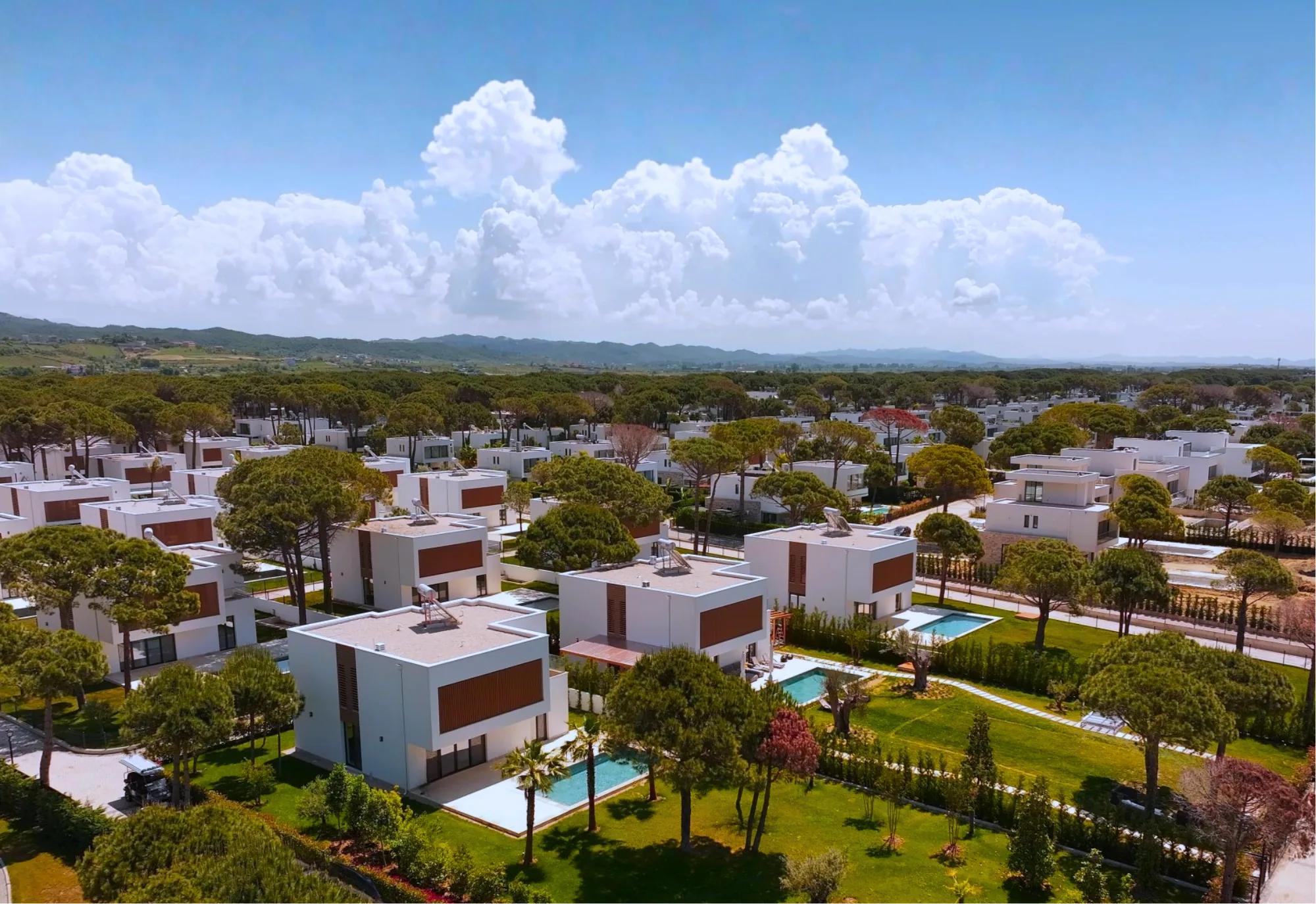 Aerial view of the San Pietro villa community set among the pine forest