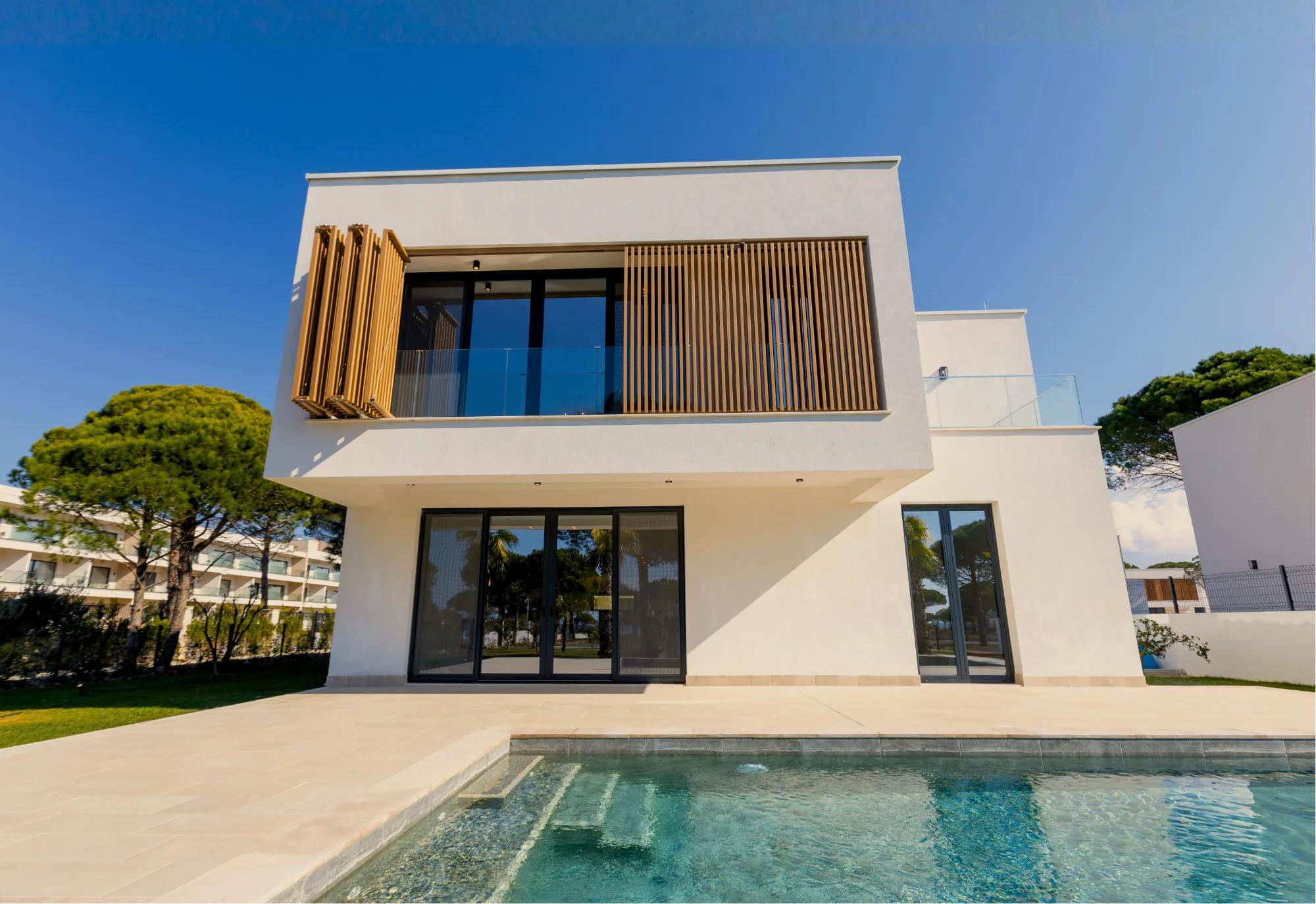 A villa's pool terrace and glazed rear elevation