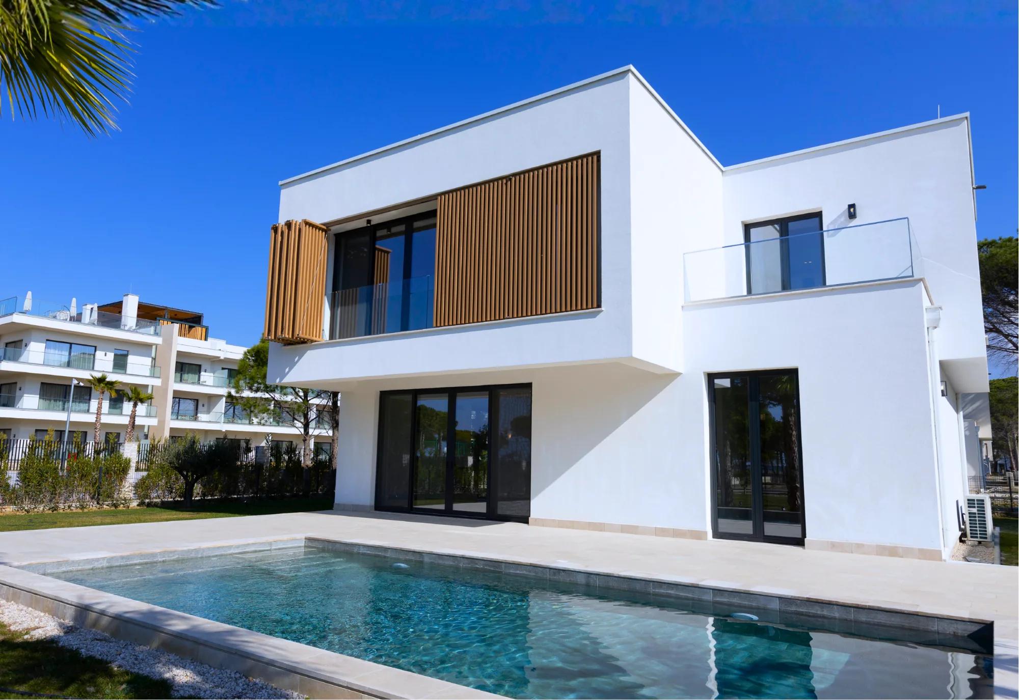 A villa's timber-screened upper storey above the pool terrace