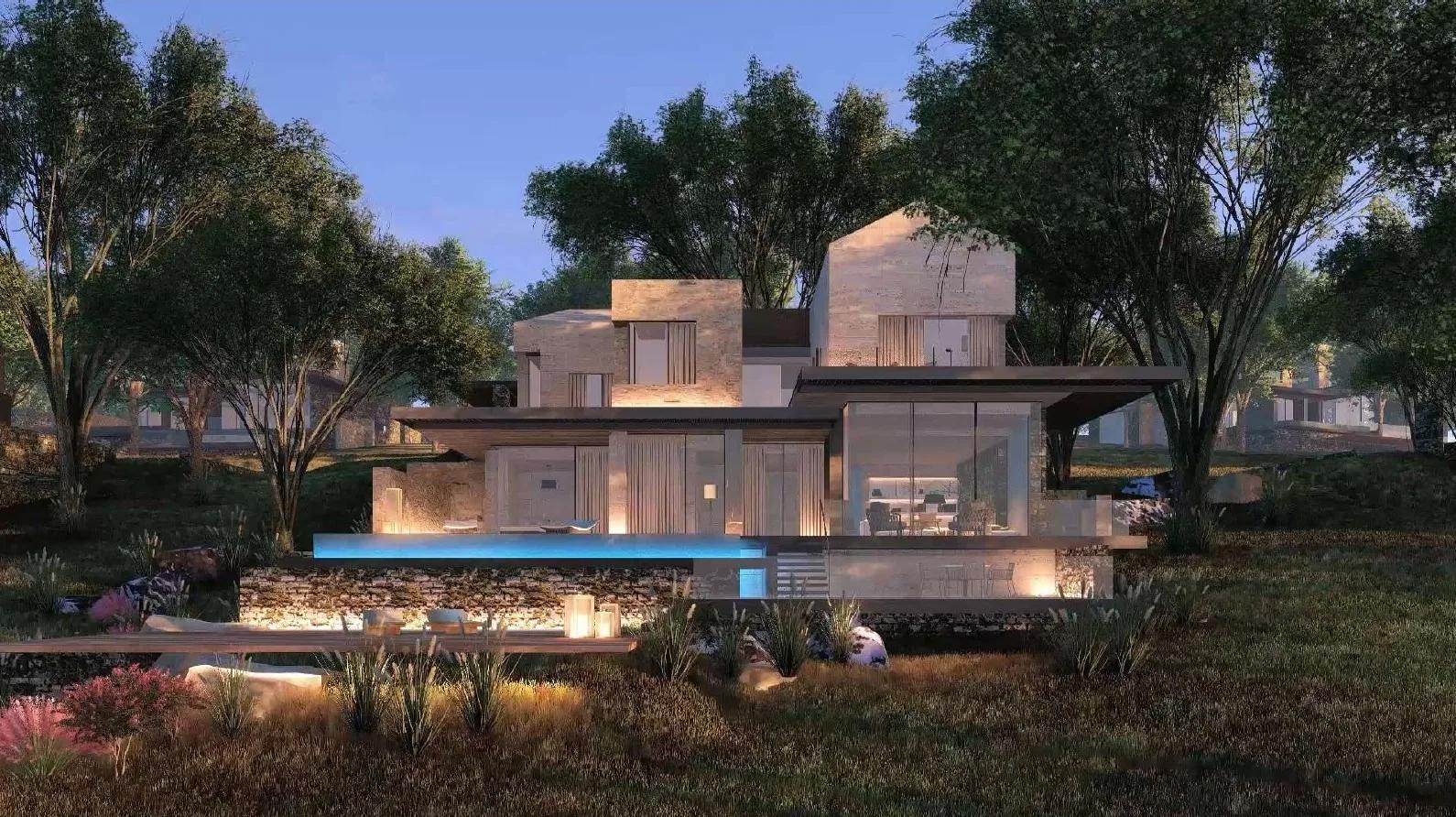 A private villa and infinity pool lit at dusk