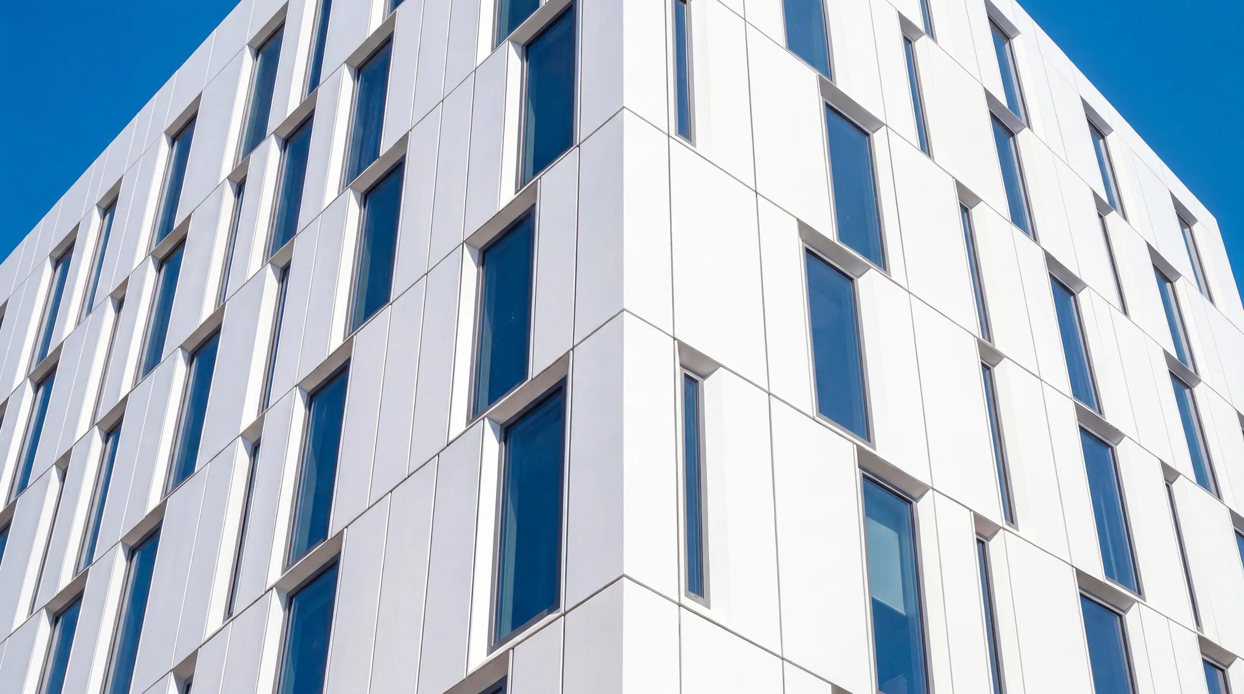 Close detail of the folded white facade panels